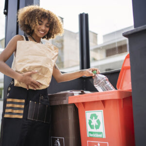 African american young woman recycling garbage. Sustainability concept. Go Green
