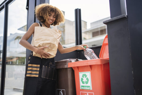 African american young woman recycling garbage. Sustainability concept. Go Green