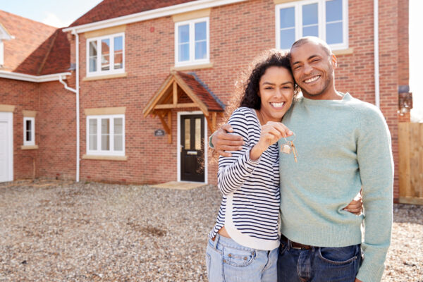 Portrait Of Couple Holding Keys Standing Outside New Home On Moving Day Dynasty TV | Minnesota Spokesman-Recorder | Bremer Bank